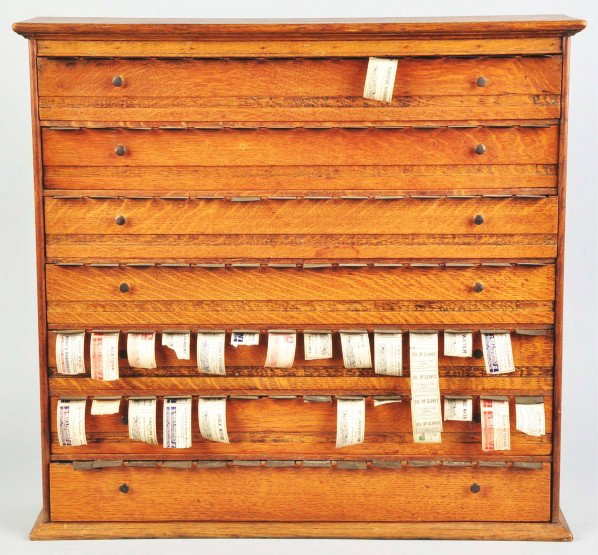 Oak Pharmacy Cabinet.: Description Circa 1900. Still retains a number of labels. Some dark stains and marks to refinished case. Light to moderate overall wear otherwise. Condition (Very Good Plus). Size 27 - 1/2" x 26" x 7 