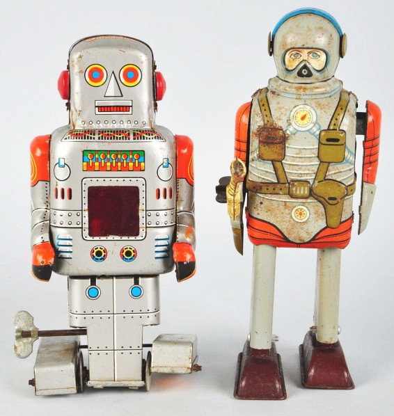 Lot of 2: Tin Litho Wind-Up Robot Toys.: Description Japanese. Includes one Space Commando with original gun but missing plastic helmet. Also includes one SY walking robot. Some pitting and rust to upper half of Space Commando. Condition (Go