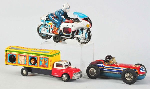 Lot of 3: Tin Litho Friction Toys.: (Very Good). Largest: 10" L. Japanese. Working. Includes one World's Circus truck, one 54 Rocket Racer, and one police motorcyclist. All with some overall wear.