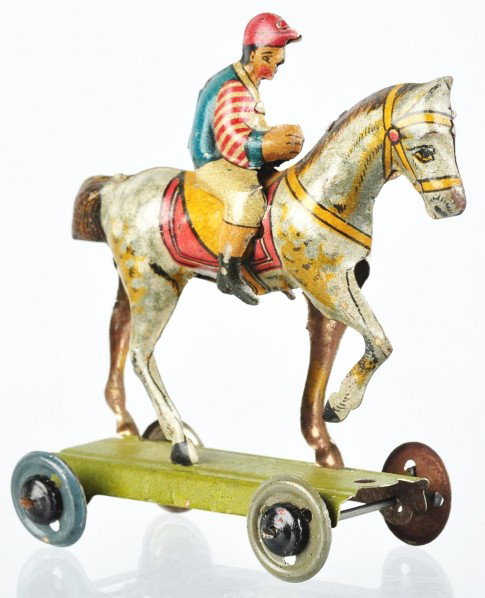 Tin Litho Jockey on Horse Penny Toy.: Description German. Marked "Germany" on underside of horse. Nice multi-colored lithography. Very little wear overall. Condition (Excellent). Size 2 - 3/4" L.