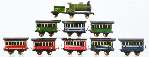 Tin Litho Train Set Penny Toy.: Description German. Includes combination engine tender on one platform, engine with original smoke stack and marked "278" while tender is marked "GNR". Also includes eight red, blue, and green passeng