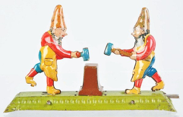 Tin Litho Gnomes Penny Toy.: Description German. Push-lever activated. Gnomes take turns hitting anvil with hammers. Some wear to base and minor scratching to figures. Condition (Very Good). Size 4" L.