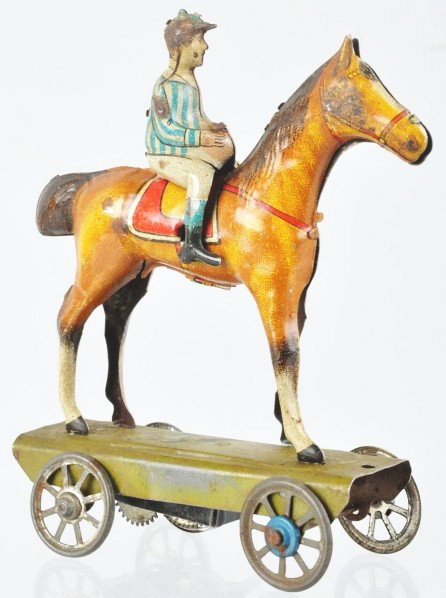 Tin Litho Jockey on Horse Wind-Up Nickel Toy.: Description German. Marked "Germany" under saddle of horse. Some scratching to base and a few nicks to lithography on horse. Condition (Very Good). Size 5" T.