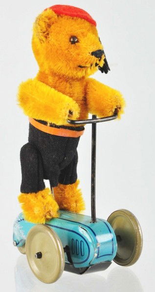 Schuco Bear on Scooter Wind-Up Toy.: Description German. Working. Includes original hat and tassel. Tin scooter has some scratching and paint loss on back. Condition (Excellent). Size 6" T.