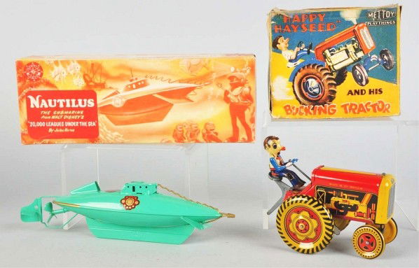 Lot of 2: Tin Wind-Up Toys.: Description English. Working. Includes one Walt Disney Nautilus Submarine and one Mettoy tractor. Includes both original boxes with some creasing. Condition (Very Good - Excellent). Size Largest: 10"