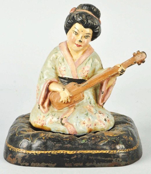 Cast Iron Geisha Girl on Pillow Wearing Kimono.: Description Made by Hubley. Three piece casting. Condition (Good). Size 6 - 1/2" T.