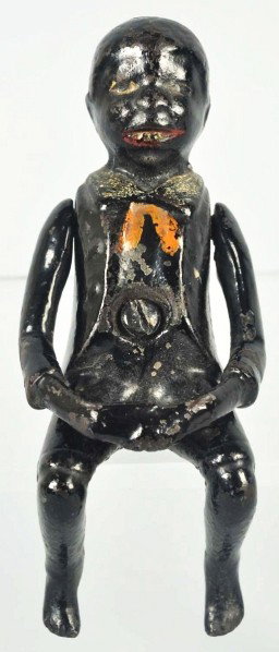 Cast Iron Ives Black Americana Broom Holder.: Description Circa 1890s. Scarce and novel design. Depicts a seated black figure able to raise arms and hold a broom handle. Center of chest accepts a screw for wall mount. Condition (Near Mint). Size 