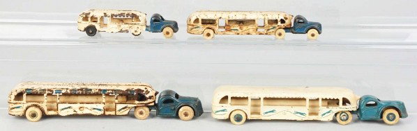 Lot of 4: Cast Iron Arcade Greyhound Bus Toys.: Description American. Includes three Century of Progress tractor trailers. One has replacement tires and one is missing a tire. Condition (Good - Very Good). Size Largest: 10" L.