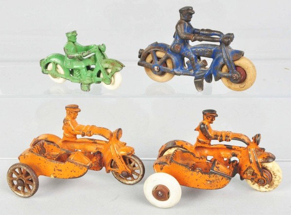 Lot of 4: Cast Iron Motorcycle Toys.: Description American. Includes two with sidecars, one with replacement rubber tire, and one cop bike. All with some paint loss and wear. Condition (Very Good). Size Largest: 4" L.