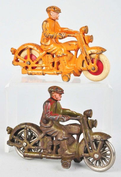 Lot of 2: Cast Iron Hubley Motorcycle Toys.: Description American. Both with civilian riders and marked "Harley Davidson" on gas tanks. One with white rubber tires and the other with nickel wheels. Green motorcycle with red paint splattered on h