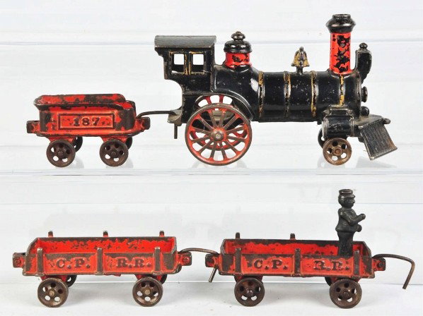 Cast Iron C.P.R.R. Floor Train.: Description Includes steam engine with cowcatcher, no. 187 tender, and two C.P.R.R. gondola cars. One gondola car with attached figure. Some moderate paint loss and wear to cars. Condition (Very Good)