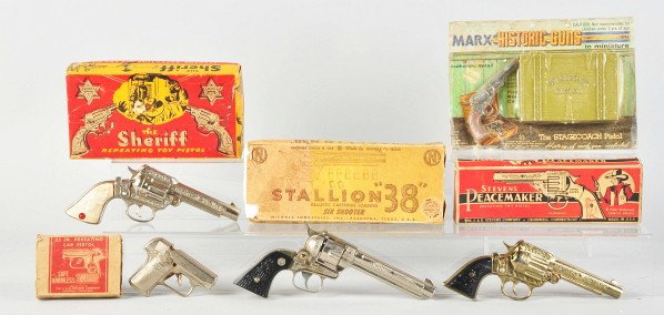 Lot of 5: Cap Pistol Toys.: Description American. Two are made by Stevens. Includes all original boxes, a few with missing end flaps. Condition (Very Good). Size Largest: 9" L.