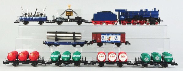 Marklin G-Gauge State Railway Freight Train Set.: Description Contemporary. Includes no. P81164 engine and tender with eight different cars. Cars consist of one boxcar, one flat car with thermos, one gondola with two glasses, and tank cars. Includes 