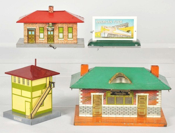 Lot of 4: American Flyer Stations & Billboard.: Description Mostly tin. Includes one Central Station with name plaque, one American Flyer billboard with Santa Fe train pictured, and two other small buildings. Condition (Very Good).