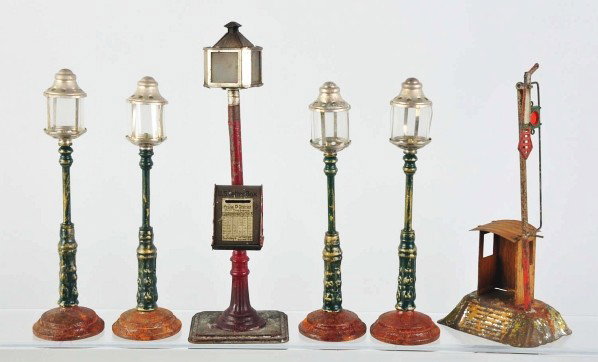 Lot of 6: Lamp Train Accessories.: Description German and reproduction. Includes one original signal shed and one original mailbox along with four contemporary lamp poles. Some scratching and wear overall. Condition (Very Good).