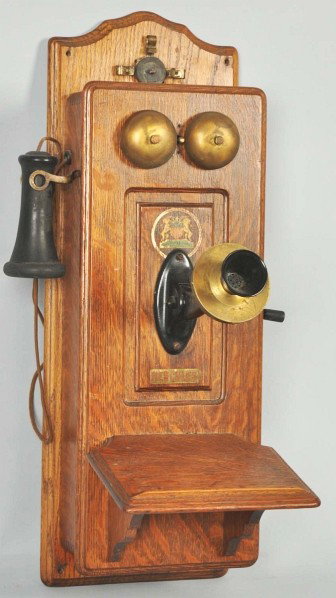 Swedish American CTPFF Wall Telephone.: Description Circa 1905. Oak. Converted for use, rotary dial and ringer installed in battery compartment, bells/transmitter/hook brassed out. Condition (Excellent). Size 26" T.