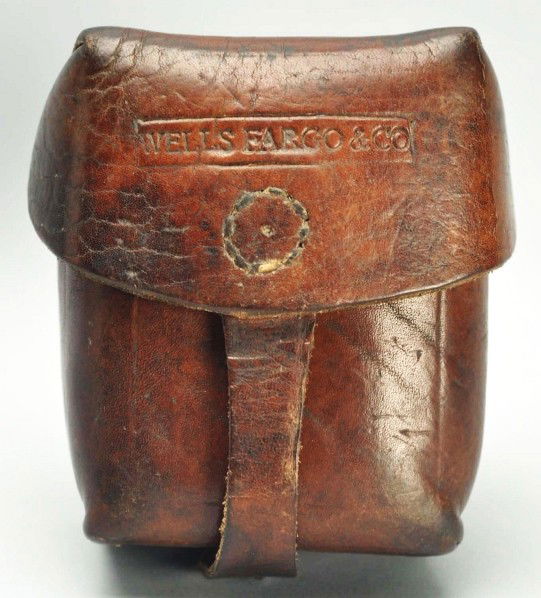 Wells Fargo & Co. Brown Leather Cartridge Box.: Description This is an important accessory marked “Wells Fargo & Co”, and while missing its wooden insert, the leather is in very good condition. There is an “inked” name on the inside of the