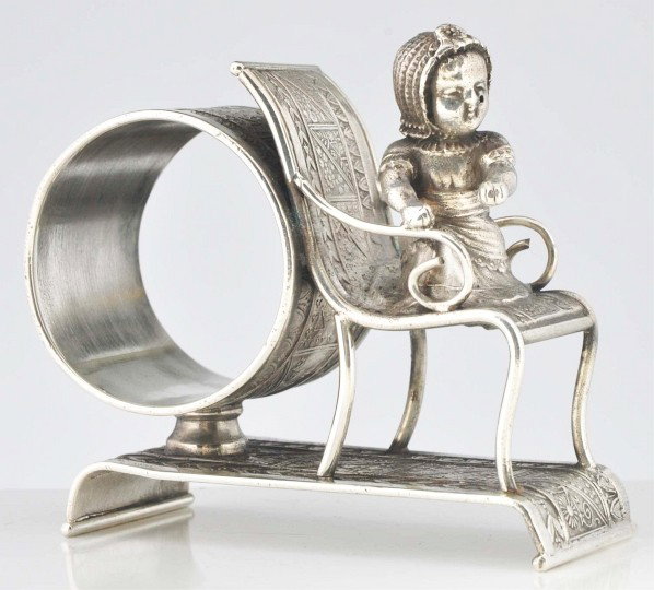 Kate Greenaway Baby in Chair Figural Napkin Ring.: Description By Middletown Plate Co. Condition (Excellent). Size 3 - 1/2" L.