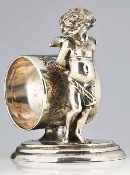 "Bashful Angel" Figural Napkin Ring.: Description Angel stands in front of pedestaled napkin holder. By James W. Tufts. Condition (Excellent). Size 3 - 1/2" T.