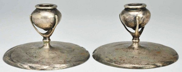 Pair of Arts & Crafts Silver Plated Candlesticks.: Description Each with a circular slightly domed base and vase-form nozzles held by three thin prongs, all with a pebbly finish. Marked TIFFANY STUDIOS/ NEW YORK/ 1213 (one); 1312 (the other. Wear and