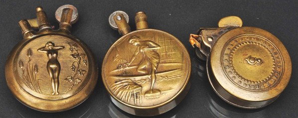 Lot of 3: Brass Trench Lighters.: Description Two with women on them and one marked "Repeating Light Company". All appear to be functional. Condition (Excellent). Size Each: 1 - 1/2" Dia.