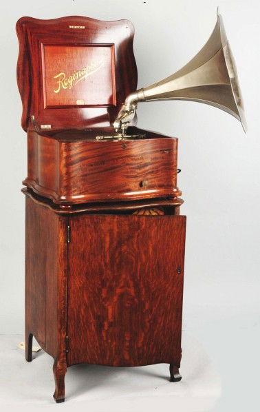 Reginaphone 15 - 1/2" Style 150 Music Box.: With silver horn and 22 discs. Cabinet is oak and music box is mahogany. Condition (Good). Size 44 - 3/4" x 22".