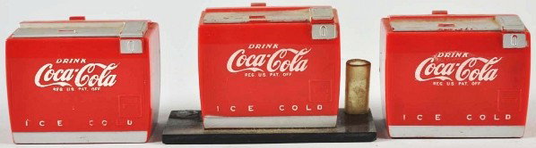 Lot of 3: Coca-Cola Music Boxes.: 1950s. One acts as a pen holder, one is currently not working, and the other plays softly. Light to medium overall wear. Condition (Very Good). Size Each: 2 - 3/4" L.