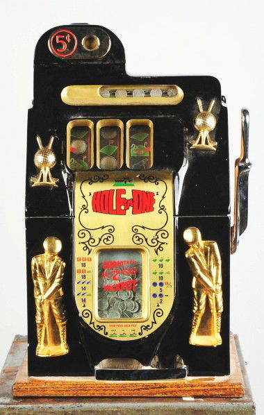 Mills 5¢ Hole-in-One Golf Ball Motif Slot Machine.: Original mechanism. Reproduction wood and castings. Condition (Excellent). Size 25" T.