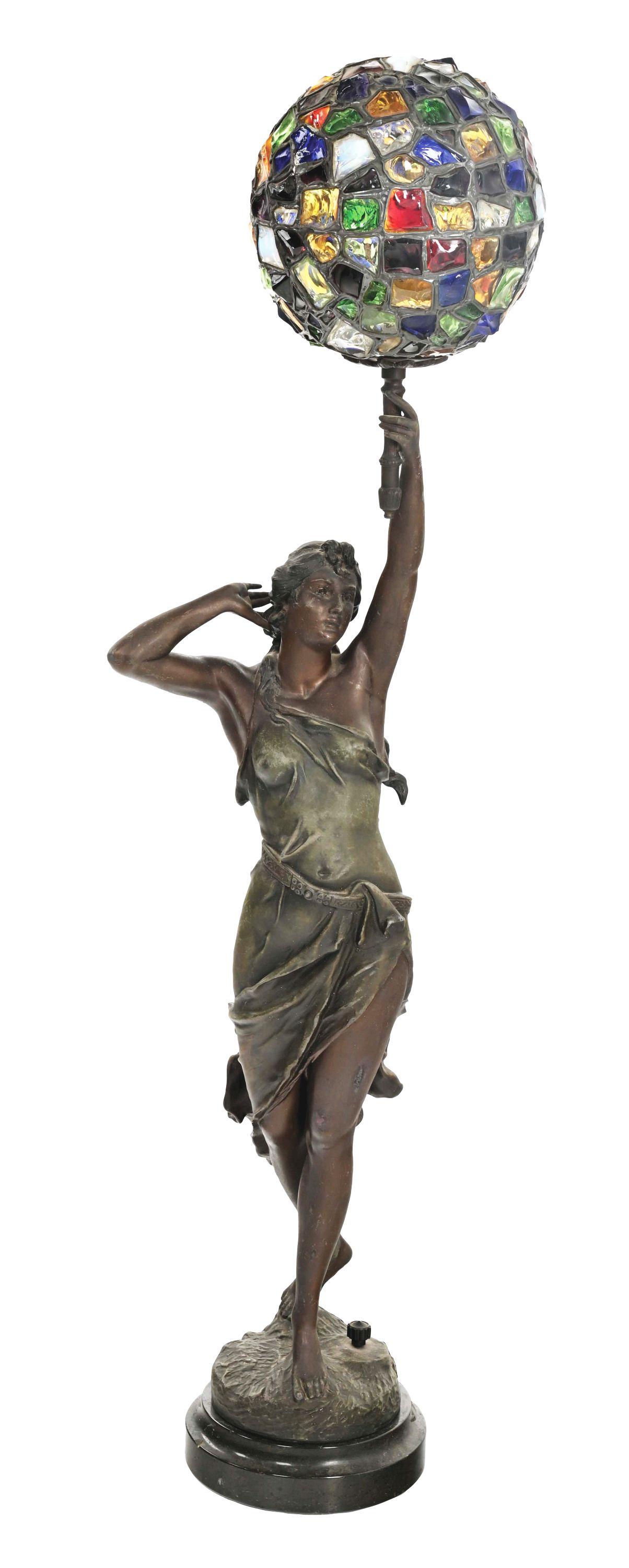 BRONZE LAMP OF WOMAN HOLDING STAINED CHUNK GLASS BALL SHADE.: Comes with black granite base. Condition: Some minor oxidation to the metal patina. Condition: (Very Good). Dimensions: 9" x 7 - 1/2" x 41".