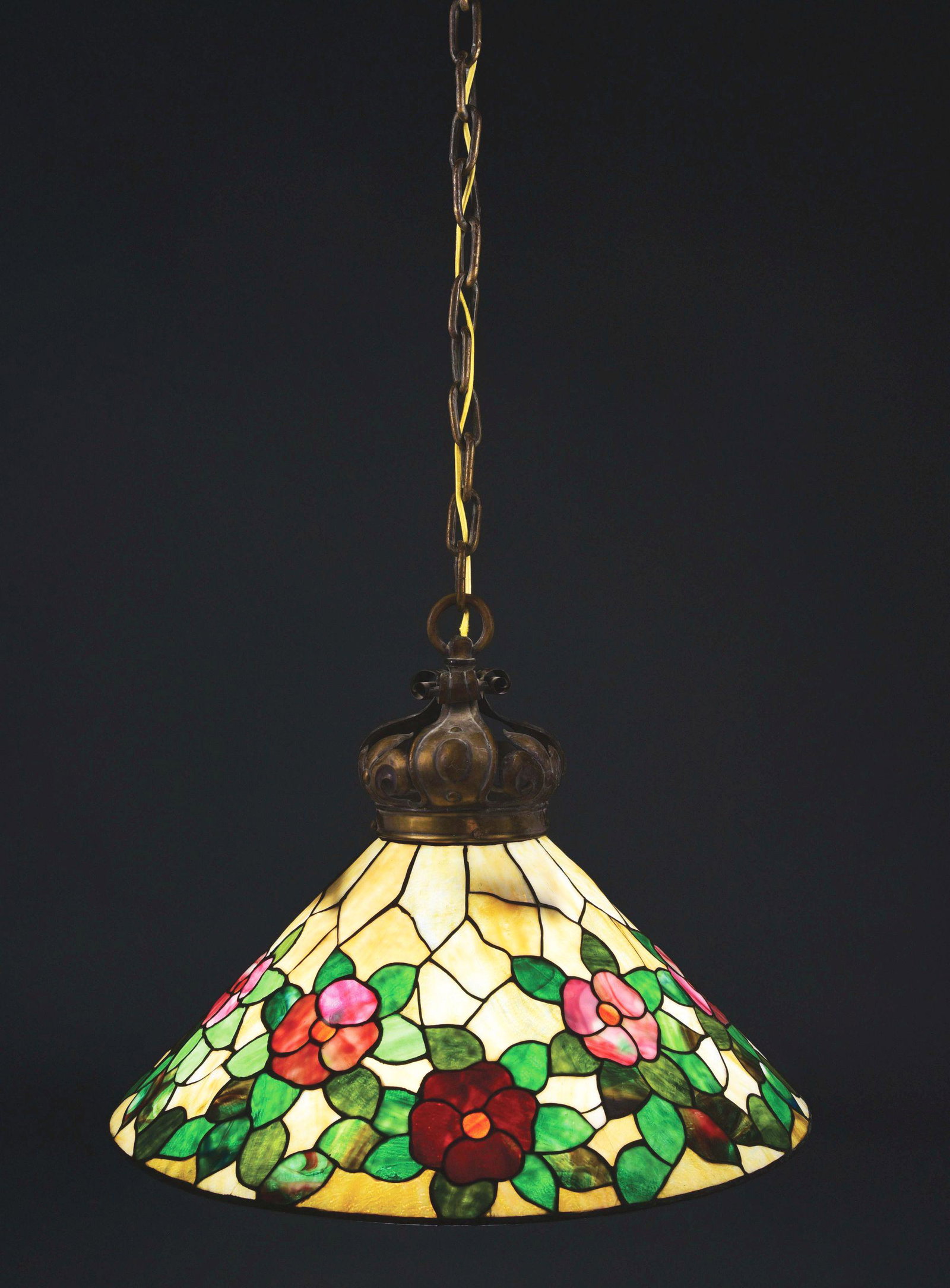 COLONIAL ART GLASS LEADED GLASS HANGING LAMP.: A beautiful floral leaded glass hanging lamp by Colonial Art Glass Company. The 26" diameter conical shade features a background of streaked caramel-colored glass that is granite-backed. The shade is 