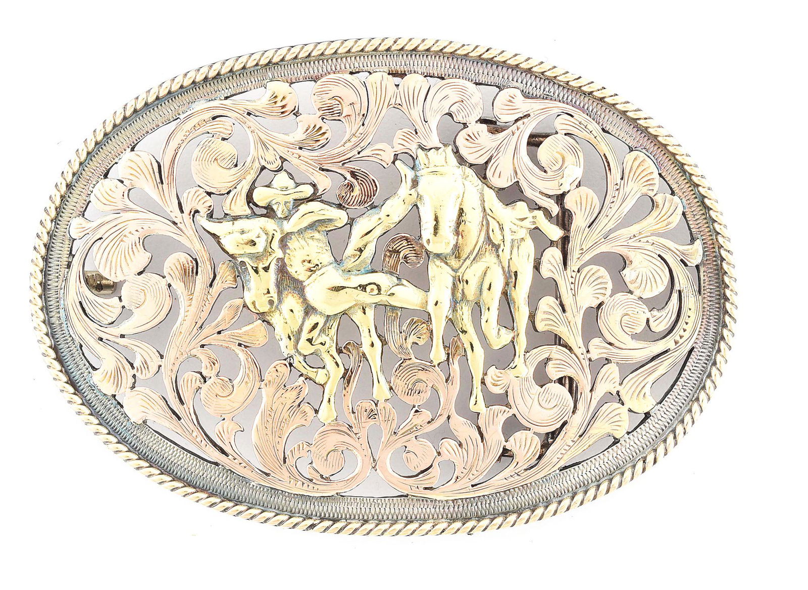 EDWARD H. BOHLIN FILIGREED BULL DOGGING BUCKLE: Measuring 2 - 1/2" x 3 - 1/2", this impressive and intricately filigreed steer wrestling/bull dogging oval Bohlin buckle is executed in sterling silver and overlaid with 3-color, 10K & 18K yellow, ros