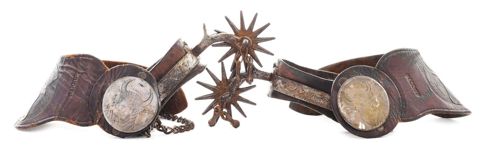 EARLY AUGUST BUERMANN SPURS WITH GALLUP STRAPS: The scarce and desirable 1287 pattern. Marked on the band "Buermann's Patent", backed with 1 - 1/2" riveted leather, one with the barely visible Buermann mark. These have the large full drop 2" shanks