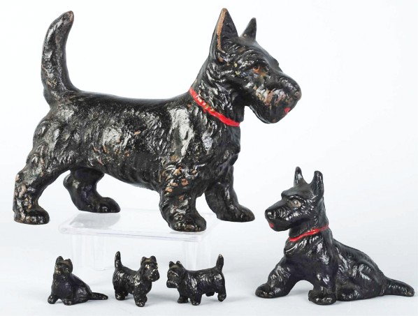 Lot of 5: Cast Iron Scottie Pieces.: Includes Sitting Scottie paperweight, Standing Scottie doorstop, and three miniature Scottie Party Favors. Condition (Excellent). Size Largest: 5" T.