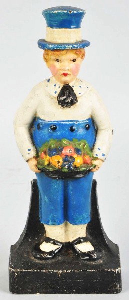 Cast Iron Boy Holding Fruit Basket Doorstop.: Boy in top hat holding fruit basket. Condition (Excellent). Size 7" T.