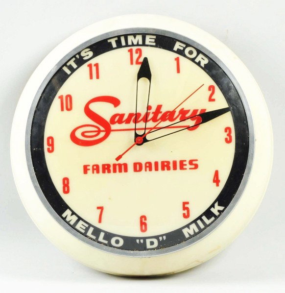 Sanitary Farm Dairies Lighted Clock.: 1940s to 1950s. Displays well with the exception of four or five closed cracks and some small cracks to the outer edge of the plastic frame. Light soiling and minor marks as well. Condition (Good). Si