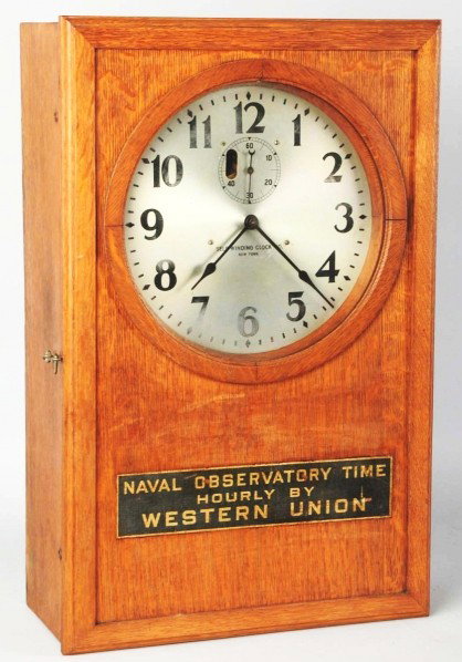 Western Union Clock.: Circa 1920s. Beautiful tiger oak wooden case on this quite heavy clock. Only moderate fading and wear to the face with general light to medium outer case wear. Condition (Very Good). Size 28" x 18".