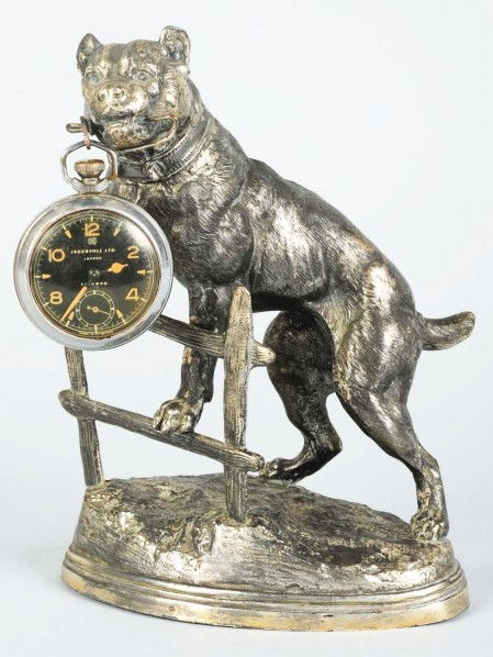 Bulldog Figural Watch Holder.: Fantastic pose of a bulldog climbing over a fence. Nice detail. Condition (Excellent). Size 8" T. ADDITIONAL INFO: Signed "C. Valton".