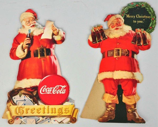 Lot of 2: Coca-Cola Santa Cutouts.: 1944 and 1945. The 1944 cutout has only minor edge wear, small marks, a few minor bends, and light wear. The 1945 cutout has some surface ripples, stronger bends, and one area of touchup. Condition (G