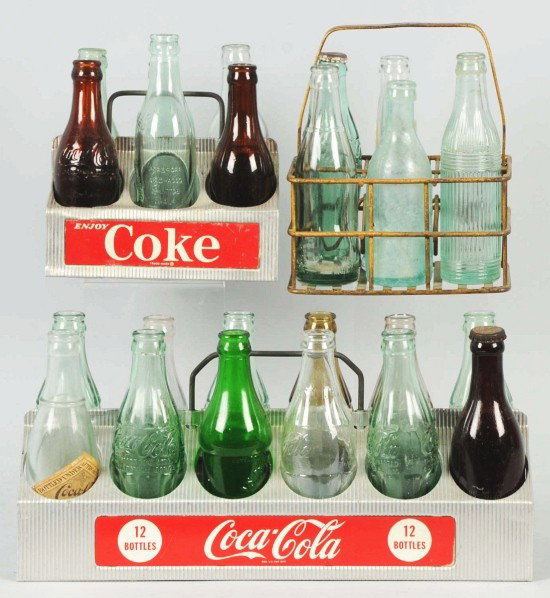 Lot of 3: Coca-Cola Carriers with Bottles.: Includes two 1950s aluminum carriers and one Property of Oklahoma plain metal carrier. Includes straight-sided amber bottles marked Cincinnati, Knoxville, and Chattanooga. Also includes clear green bo