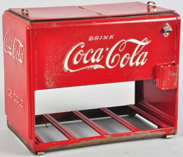 Coca-Cola Salesman Sample Cooler.: 1939. Offered with partial reproduction interior booklets. Complete with lid gasket, opener, and cap catcher. General overall medium to heavier wear with some paint chips and nicks on the lid and all 