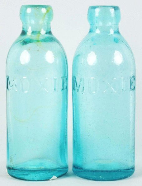 Lot of 2: Moxie Hutchinson Bottles.: 1910 to 1920s. Both bottles are very clean with some mild stains. One bottle has a few small chips and nicks at the very top. Condition (Very Good). Size 6 - 1/2" T.
