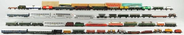 Large Lot of HO Train Engines & Cars.: American and German. Includes approximately 100 pieces, some with original boxes. Pieces include engines, cars, Marklin, etc. Various conditions. Condition (Very Good).