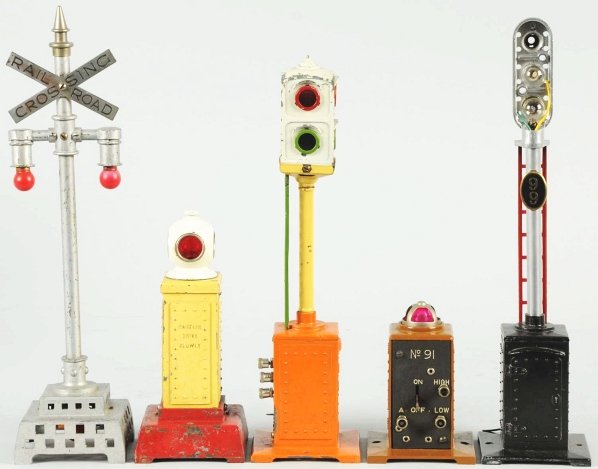 Lot of 5: Lionel Signals & Semaphores.: American. Pre-war. Includes no. 99 stoplight (missing lens cap), one railroad crossing sign, one bell signal (new top piece), and others. Condition (Very Good).