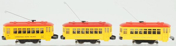 Lot of 3: Lionel No. 60 Rapid Transit Trolleys.: American. Post-war. O-27 gauge. Two with their original pulls and all with silhouetted passengers in windows. Trolley with the replacement pull also has one heat dent to top. Condition (Very Good).