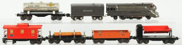 Lionel O-27 Gauge No. 1668 Freight Train Set.: American. Post-war. Includes no. 1668 bullet nose engine with matching tender, one tank car, one dump car, one gondola, one lumber car, and no. 2657 caboose. Set has minor to moderate overall wear. Co
