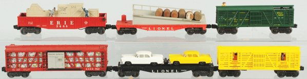 Lot of 6: Lionel Freight Cars.: American. Post-war. Includes no. 3444 Erie Hobo car, one automobile flatcar with two automobiles, one Poultry Dispatch car, one Wells Fargo Sheriff car, no. 6343 barrel car with barrels, and no. 6473