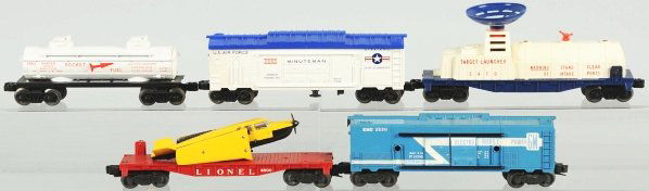 Lot of 5: Lionel Freight Cars.: American. Post-war. Includes one flatcar with airplane and original propeller, one Minuteman boxcar, one Rocket Fuel tank car, one Electric Mobile car, and one target rocket launcher car with radar di