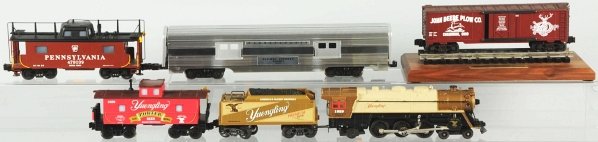 Lot of Lionel & Other Train Items.: Includes one O-27 gauge Yuengling train set with no. 1829 engine and matching tender and no. 1829 caboose. Also includes no. 46839 Pennsylvania caboose by Lionel, one 80th Anniversary John Deere boxca
