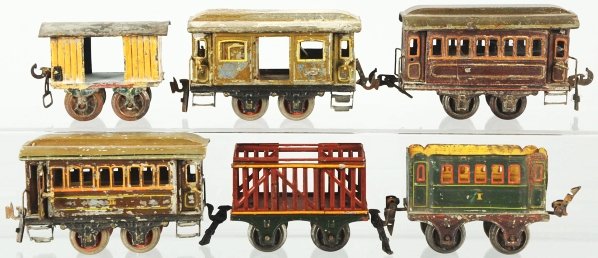 Lot of 6: Train Cars.: German. Various makers include Marklin and Carette. Combination of hand-painted and lithographed cars. Hand-painted cars have moderate paint loss, some missing wheels, and some missing roofs. Conditio