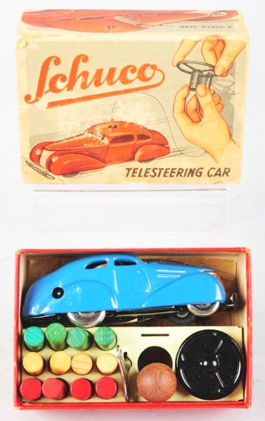 Tin Litho Schuco No. 3000 Telesteering Car Toy.: German. Wind-up mechanism is working. Marked "US Zone Germany". Complete with work bench that holds pegs, steering wheel, and Schuco key. Also has long and short control wires in original wax bags. Ve